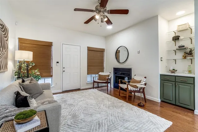 a living room with furniture a fireplace and a chandelier