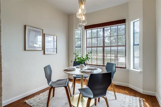 a dining room with furniture a chandelier and wooden floor