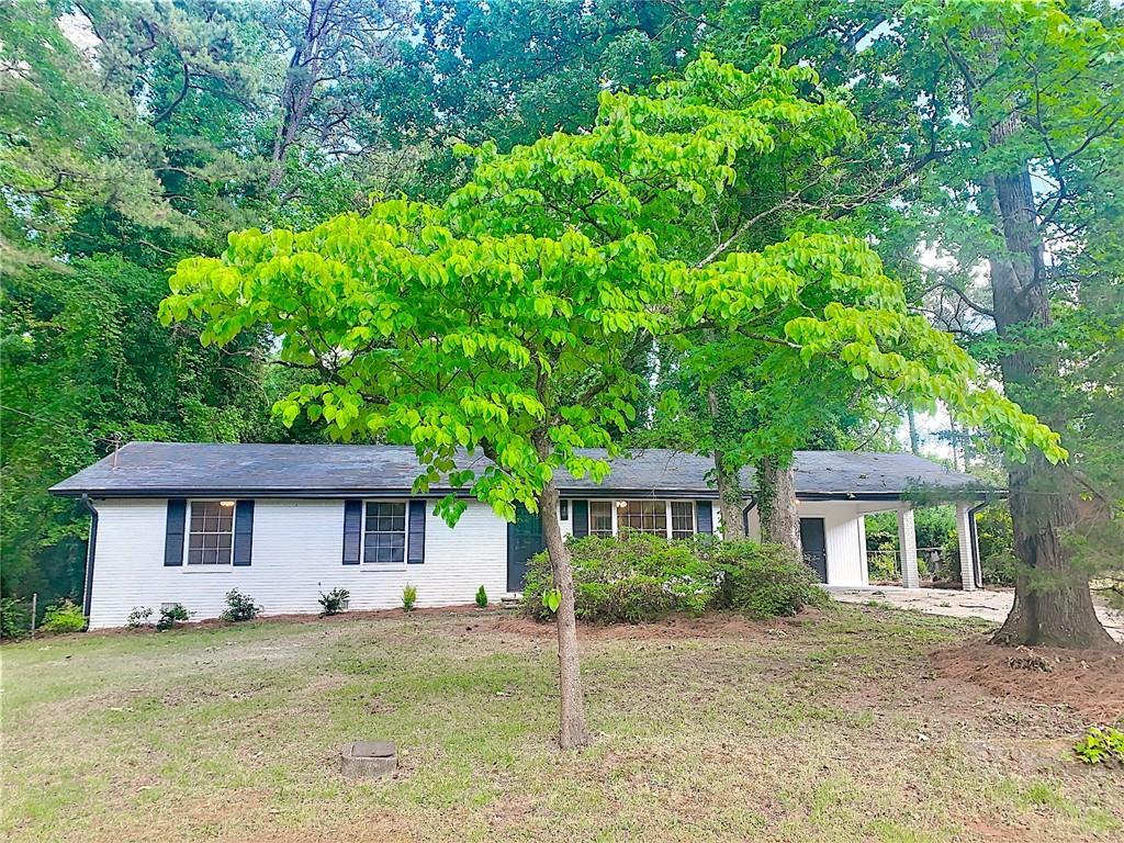 5626 Noblett Road Southwest Stone Mountain, GA 30087 - Photo 1 of 1 front view of a house with a tree