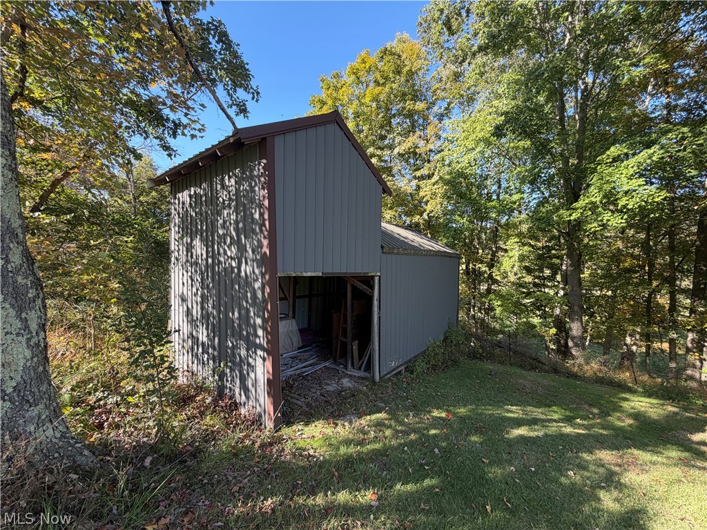 3950 Wolf Road Southwest Port Washington, OH 43837 - Photo 36 of 45 Modern metal-clad structure nestled within mature woodland setting