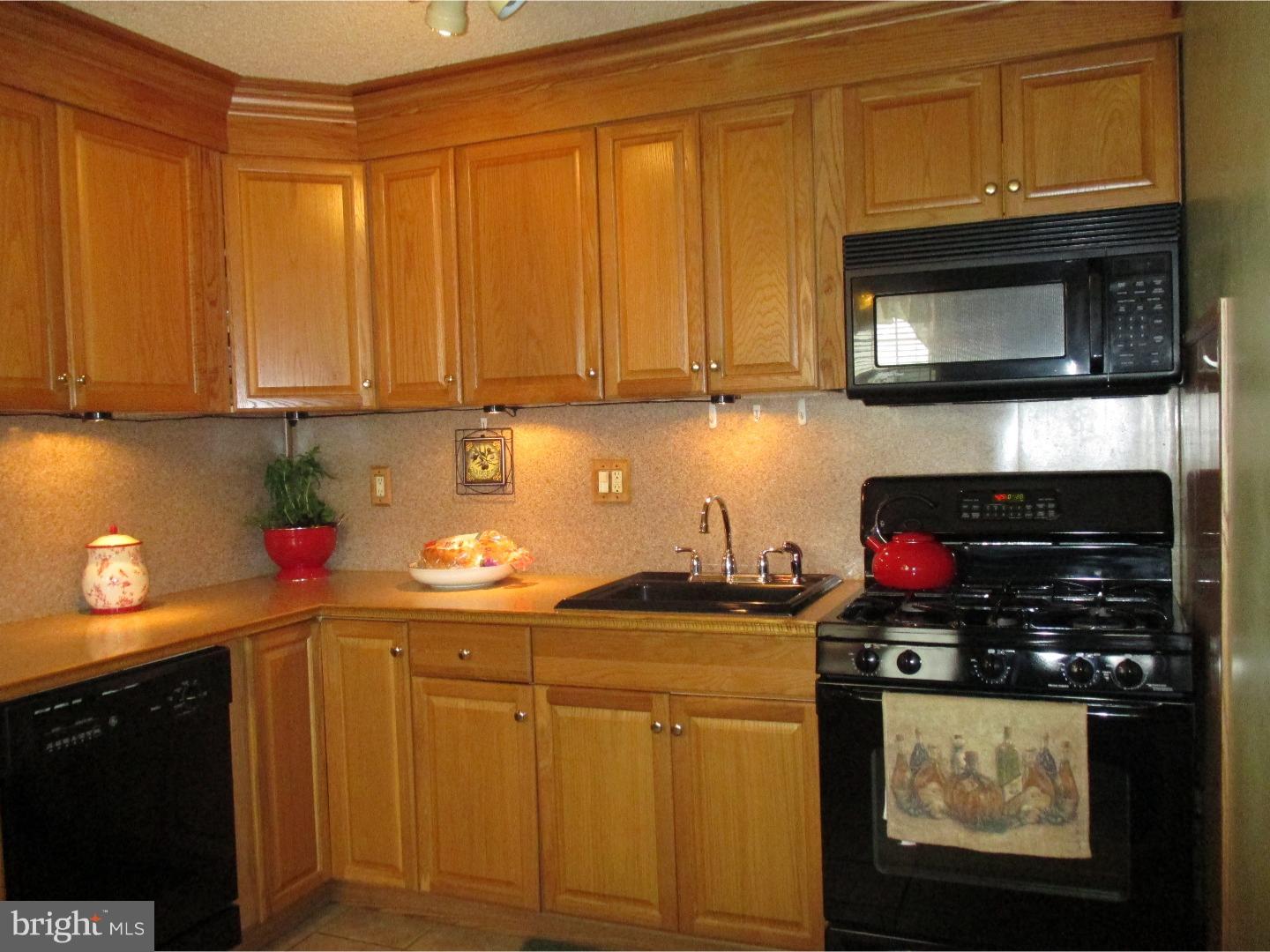 3105 Byberry Road Philadelphia, PA 19154 - Photo 5 of 7 a kitchen with a stove and a microwave