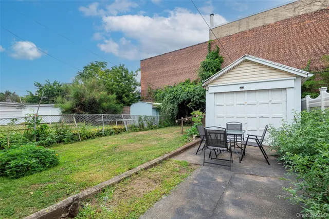 a view of backyard with seating and green space