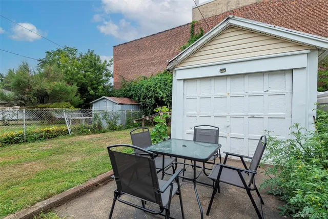 a view of an house with backyard and sitting area
