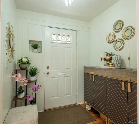 a view of a room that has a table and a chair in it
