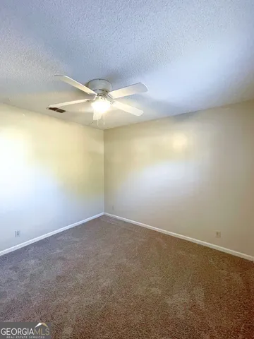 an empty room with a projector and closet