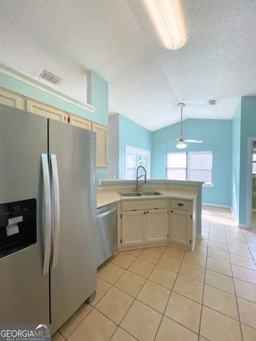 a kitchen with a refrigerator a sink and a refrigerator