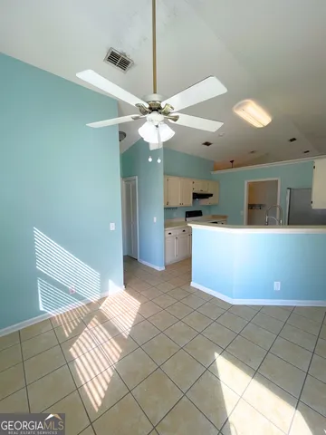 a kitchen with a sink a stove and cabinets