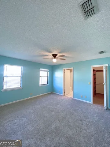 an empty room with windows and closet