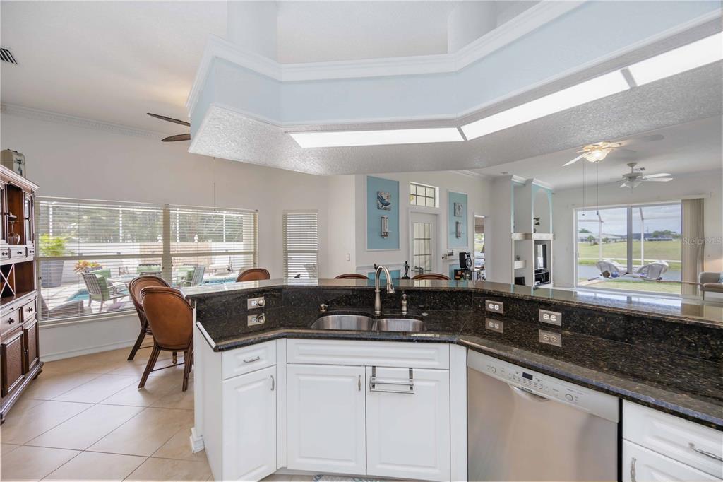 48 Bunker Road Rotonda West, FL 33947 - Photo 21 of 59 a kitchen with granite countertop a sink and a counter top space