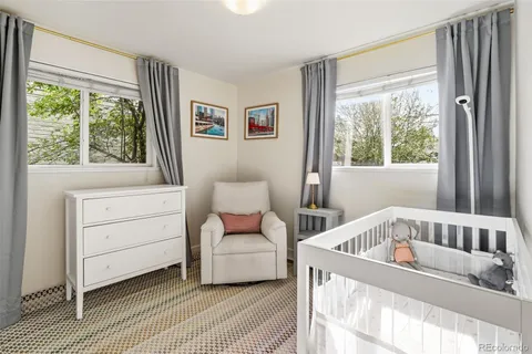 a view of a bedroom with furniture and window