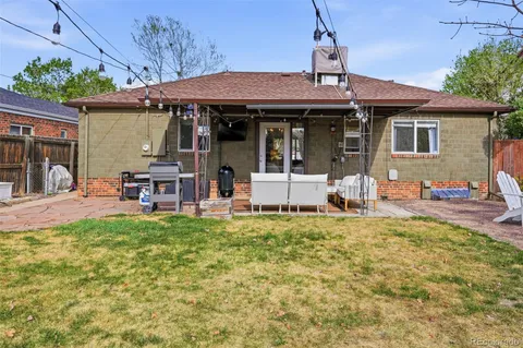 a backyard of a house with table and chairs
