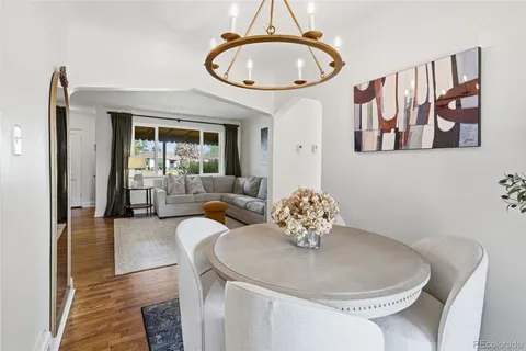 a living room with furniture flowerpot and a mirror