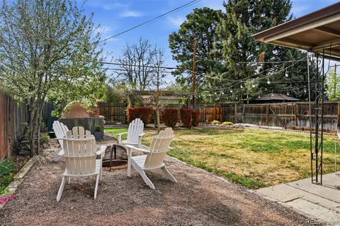 a view of a chairs and table in the backyard