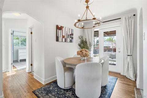 a living room with furniture a window and a chandelier