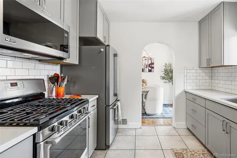 a kitchen with stainless steel appliances granite countertop a stove and a microwave
