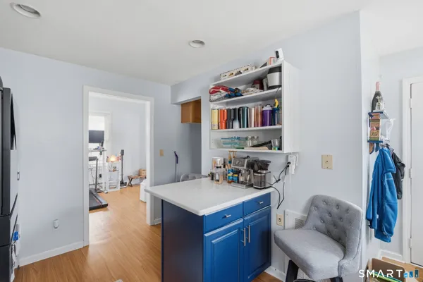a kitchen with a sink cabinets and wooden floor