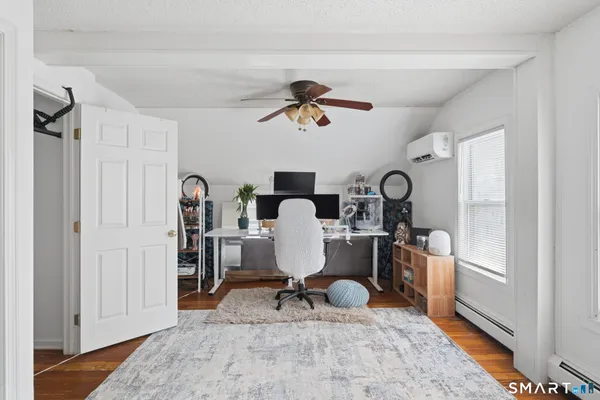 a workspace with wooden floor and a chandelier