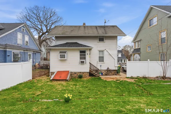 a front view of house with yard and seating area