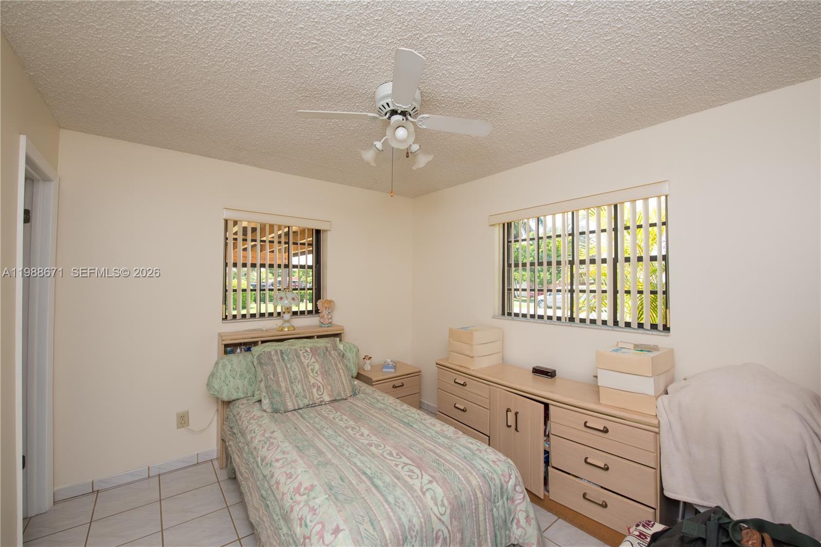 18900 Southwest 313th Street Homestead, FL 33030 - Photo 15 of 40 a bedroom with a bed and a window