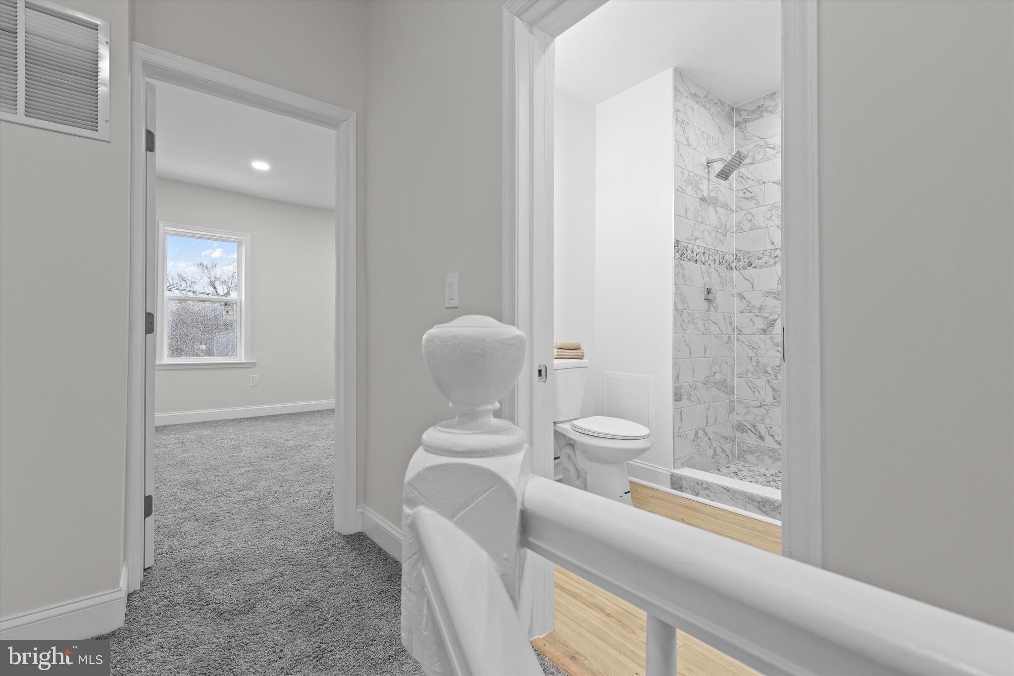 2816 The Alameda Baltimore, MD 21218 - Photo 13 of 20 a bathroom with a granite countertop toilet a sink and a mirror