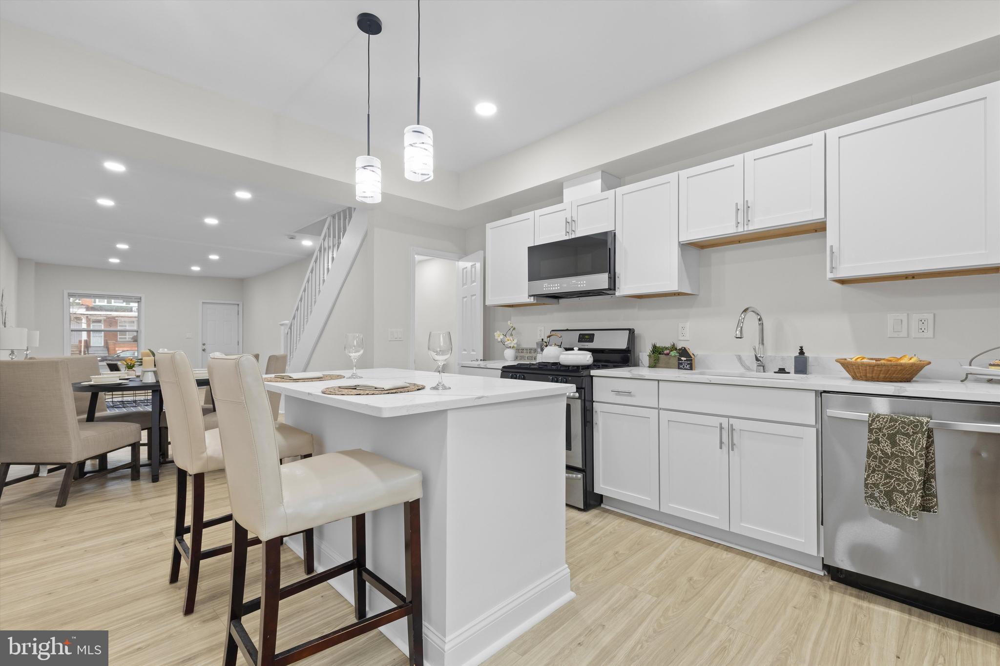 2816 The Alameda Baltimore, MD 21218 - Photo 9 of 20 a kitchen with kitchen island granite countertop a sink a center island and cabinets