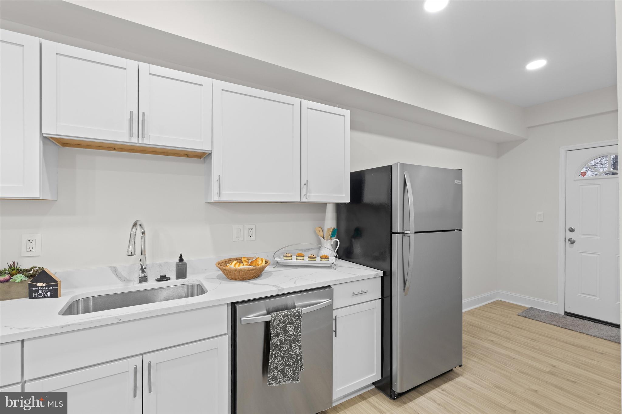 2816 The Alameda Baltimore, MD 21218 - Photo 10 of 20 a kitchen with a sink a refrigerator and cabinets