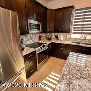 407 Camino Agua Fria Rio Rico, AZ 85648 - Photo 14 of 41 a kitchen with stainless steel appliances granite countertop a stove a sink and a microwave