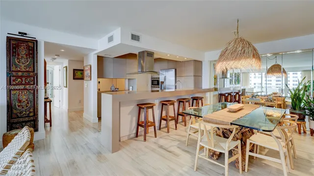 a dining room with furniture and a chandelier