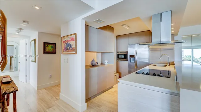 a kitchen with stainless steel appliances a stove a refrigerator and a sink