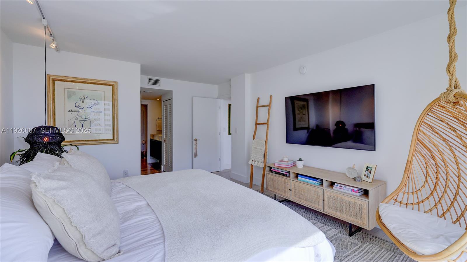 177 Ocean Ln Drive, Unit 707 Key Biscayne, FL 33149 - Photo 20 of 29 a bedroom with a bed and a flat screen tv