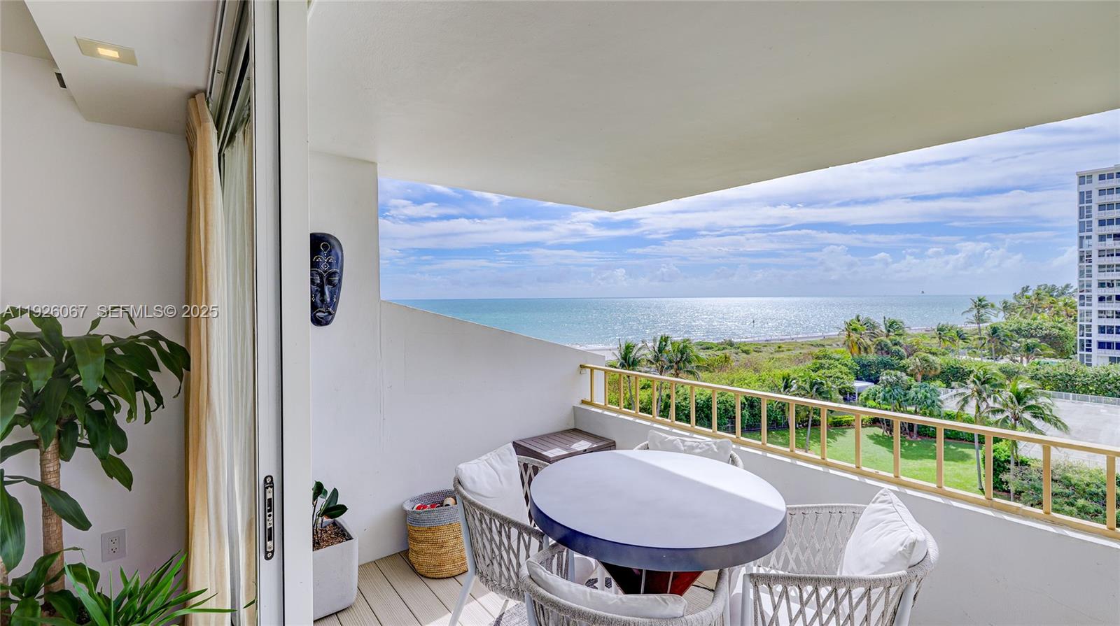 177 Ocean Ln Drive, Unit 707 Key Biscayne, FL 33149 - Photo 2 of 29 a view of a balcony with chair and potted plants