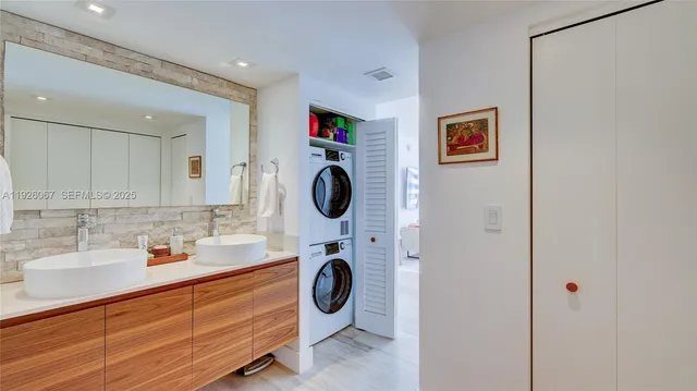 a bathroom with a sink a toilet a mirror and shower