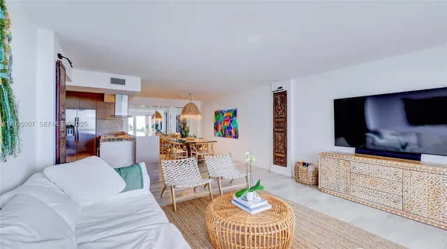 a living room with furniture a large window and a flat tv screen