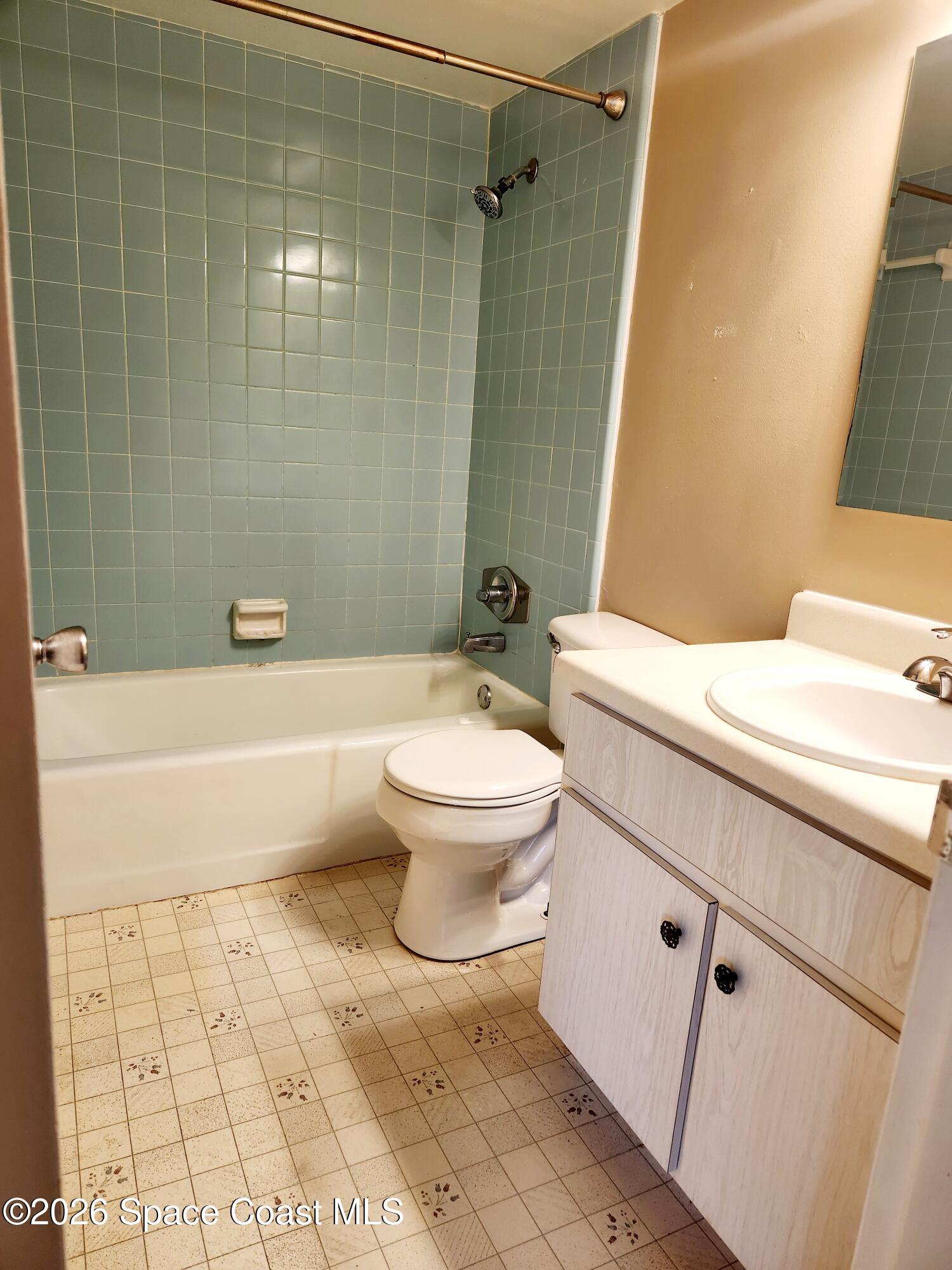 4304 London Town Rd Road, Unit 109 Titusville, FL 32796 - Photo 11 of 13 a bathroom with a sink a toilet and shower