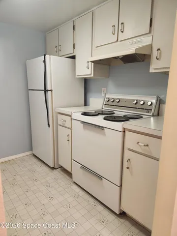 a kitchen with white cabinets
