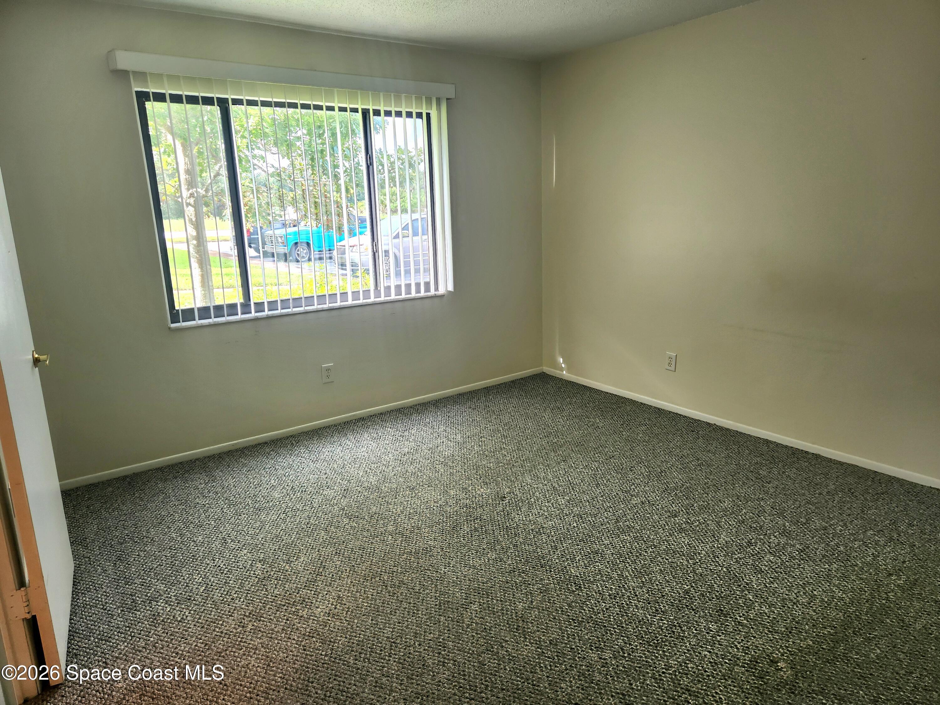 4304 London Town Rd Road, Unit 109 Titusville, FL 32796 - Photo 10 of 13 an empty room with a window
