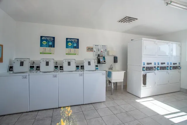 a view of kitchen with cabinets stainless steel appliances and a sink
