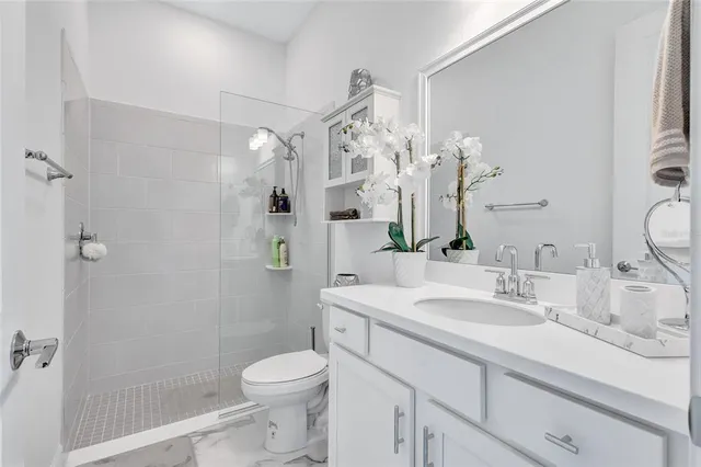 a living room with a large window and a chandelier