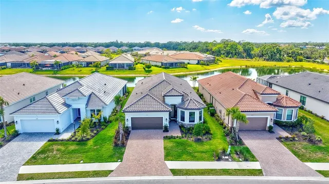 an aerial view of residential houses with outdoor space and swimming pool