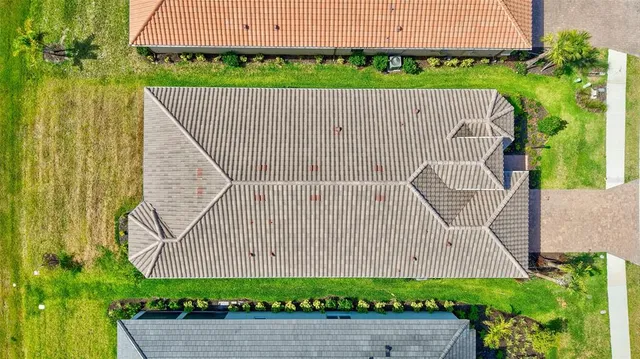 an aerial view of a house with a garden and pool