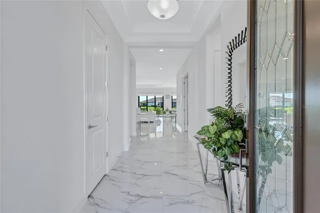 a living room with furniture flowers and a chandelier