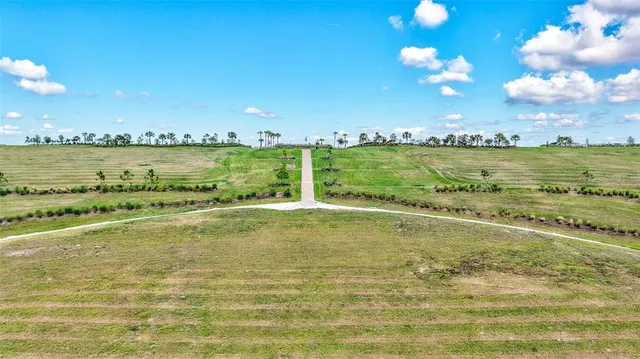 an aerial view of residential houses with outdoor space and swimming pool