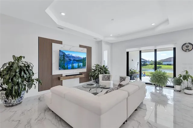 a view of a dining room with furniture and a chandelier