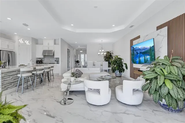 a room with stainless steel appliances kitchen island granite countertop a refrigerator and cabinets