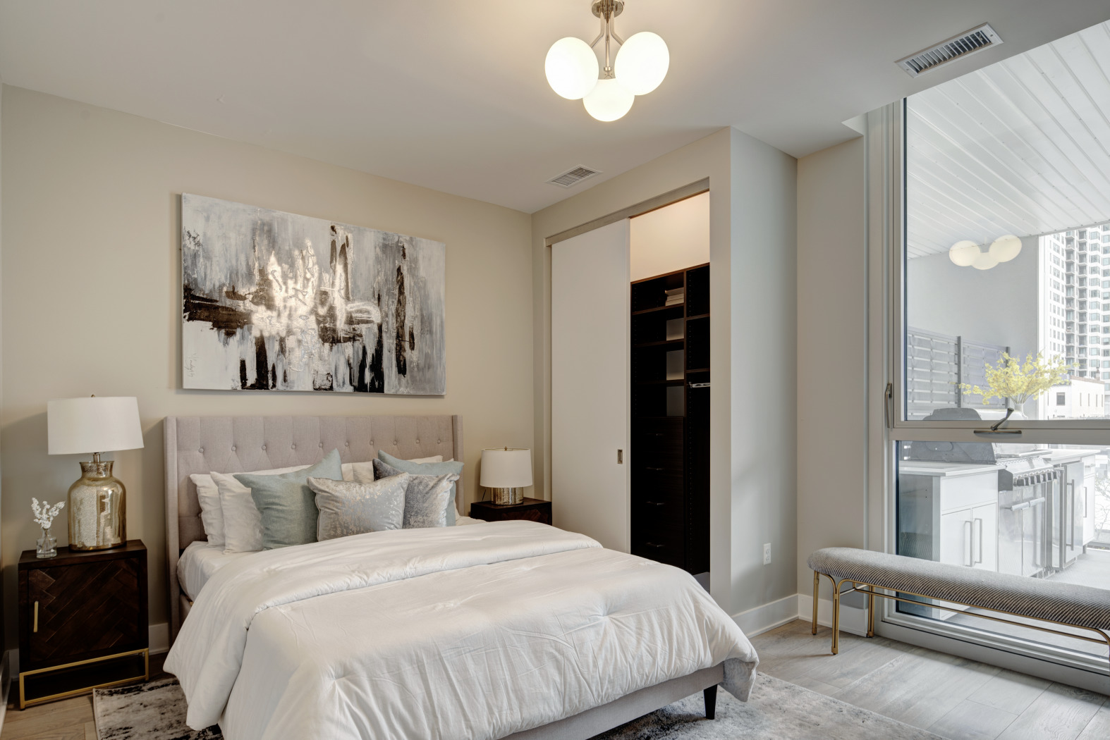 144 West Erie Street, Unit 401 Chicago, IL 60654 - Photo 14 of 25 a bedroom with a bed and a chandelier