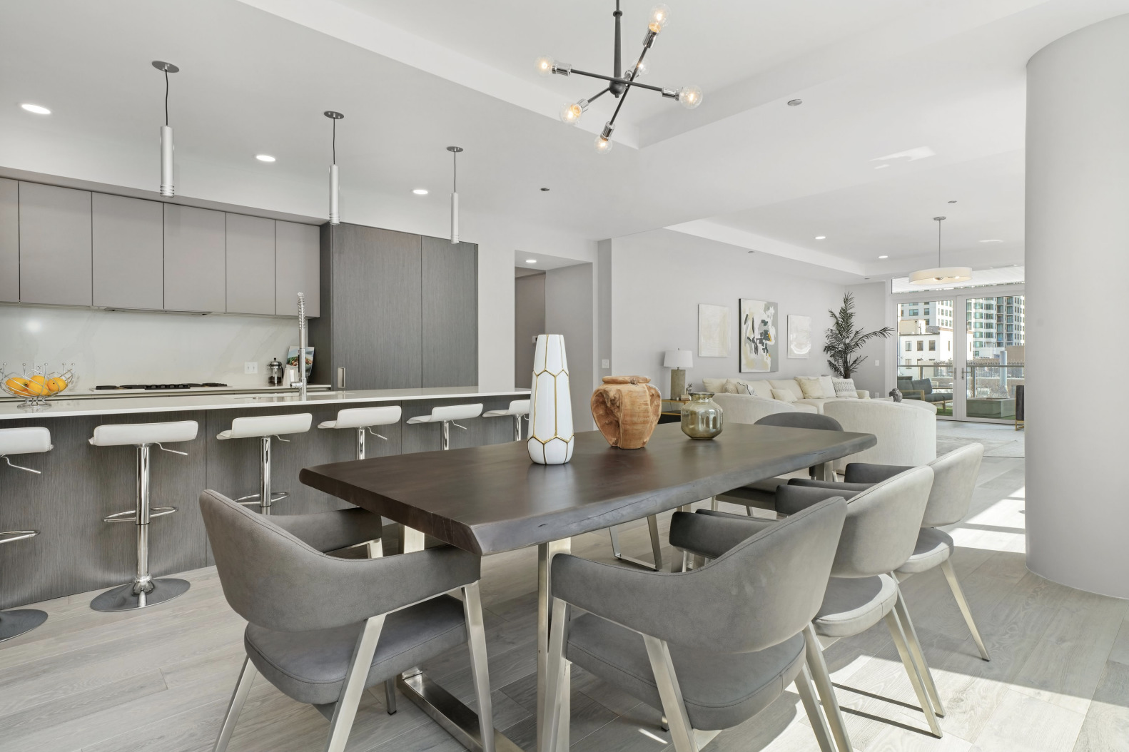 144 West Erie Street, Unit 401 Chicago, IL 60654 - Photo 6 of 25 a kitchen with a dining table chairs sink and microwave