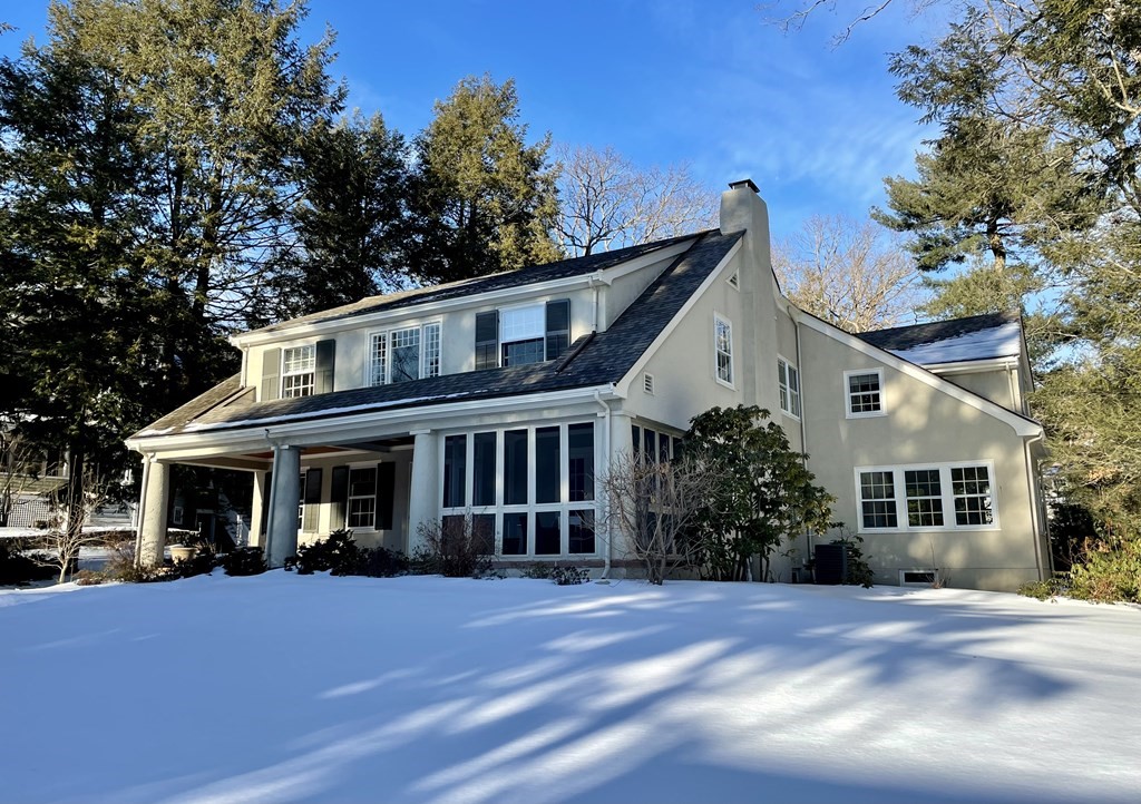 a front view of a house with a garden
