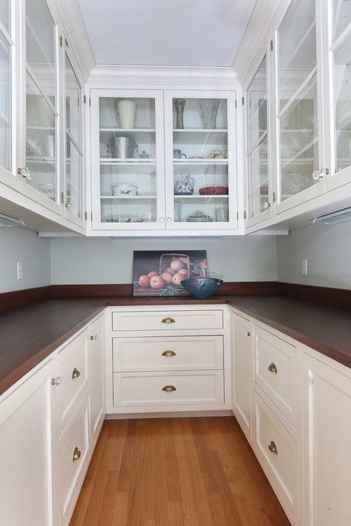 34 Livermore Road Wellesley, MA 02481 - Photo 12 of 36 a kitchen with granite countertop white cabinets and window