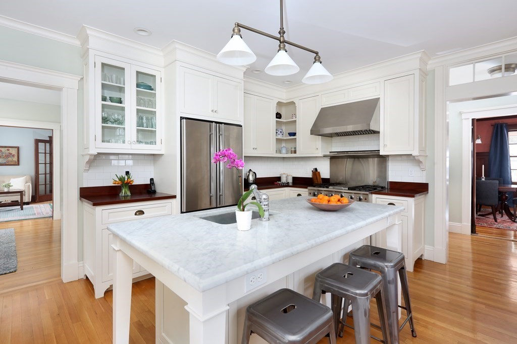34 Livermore Road Wellesley, MA 02481 - Photo 13 of 36 a kitchen with a stove a refrigerator and a dining table with wooden floor