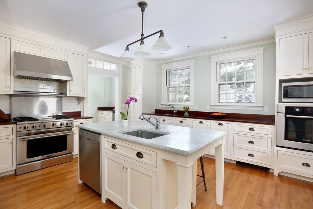 34 Livermore Road Wellesley, MA 02481 - Photo 14 of 36 a kitchen with stainless steel appliances white cabinets and wooden floor